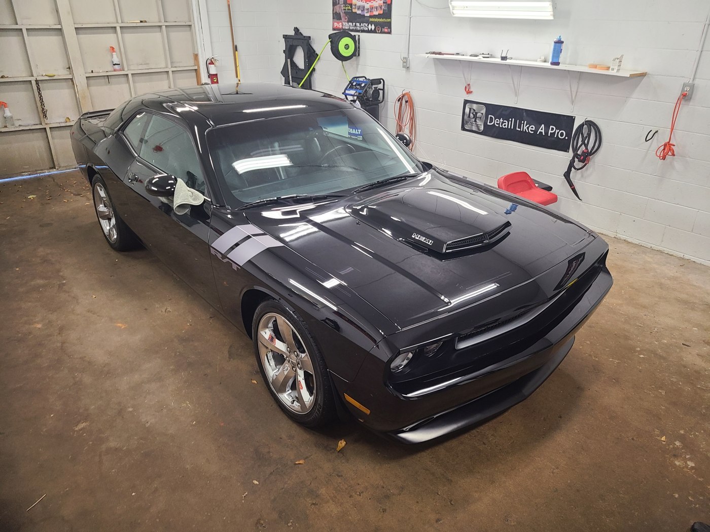 Black Dodge Challenger in the detailing bay, from Garcia’s public gallery